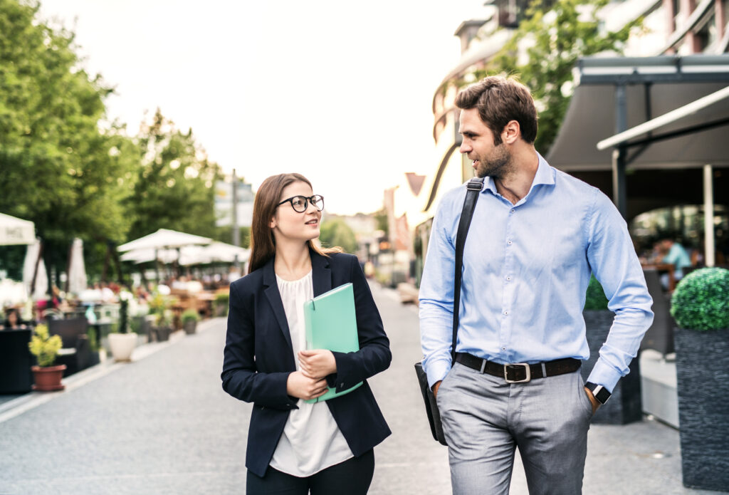 Two marketing expansion strategists walking along a street